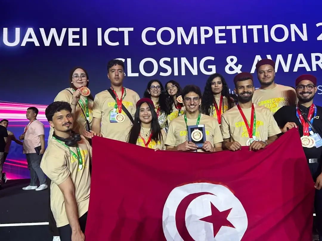 The Tunisian delegation with the flag at the Huawei ICT Competition closing ceremony